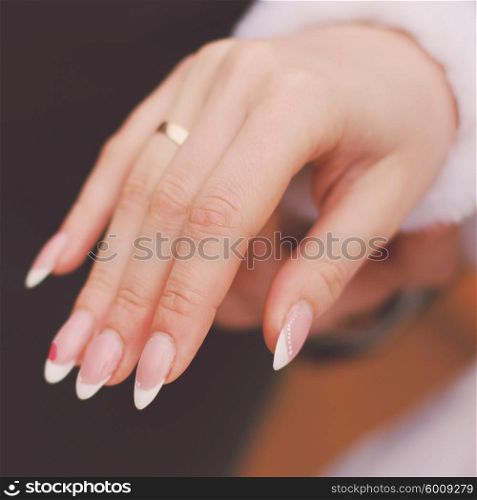 Groom putting on wedding ring