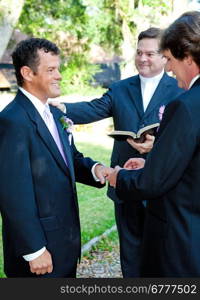 Groom slips a ring on his husband&rsquo;s finger during a gay marriage ceremony.