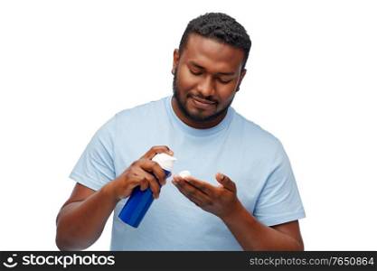 grooming and people concept - happy african american man with shaving cream over white background. happy african american man with shaving cream