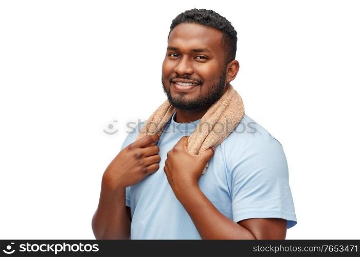 grooming and people concept - smiling african american young man with bath towel over white background. smiling african man with bath towel