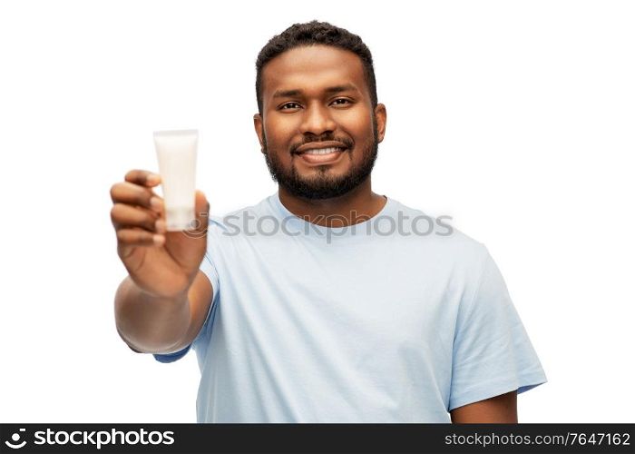 grooming, skin care and people concept - happy smiling african american showing moisturizer over white background. happy african american man showing moisturizer