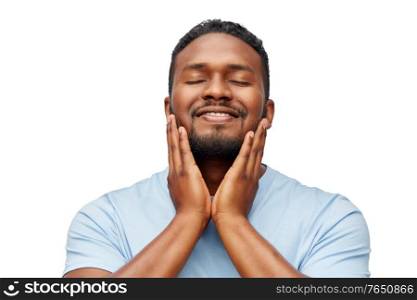 grooming, skin care and people concept - happy smiling african american touching his beard over white background. happy african american man touching his beard