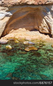 Grottoes on Spiaggia Massolivieri beach. Summer sea landscape (Siracusa, Sicily, Italy)