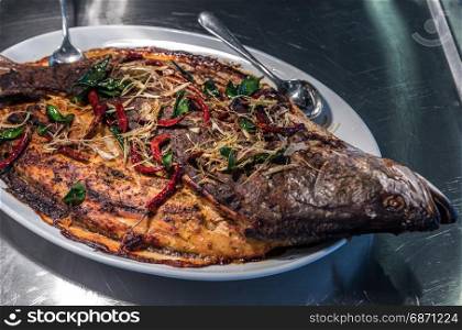 Groumet whole salmon baked with spice and herb thai style