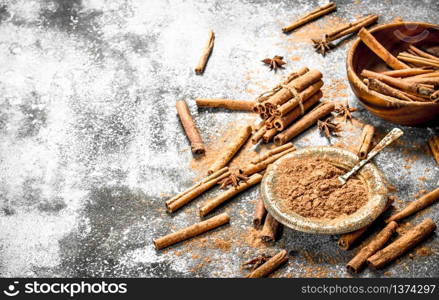 Ground cinnamon in bowls. On rustic background .. Ground cinnamon in bowls.