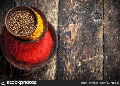 Ground spices in bowls. On a wooden background.. Ground spices in bowls.