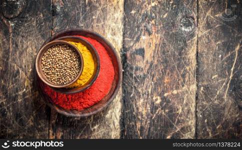 Ground spices in bowls. On a wooden background.. Ground spices in bowls.