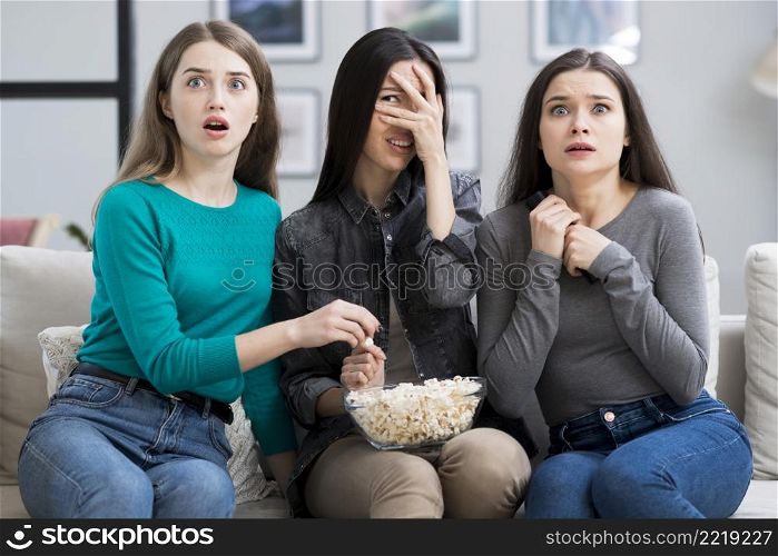group adult women watching horror movie