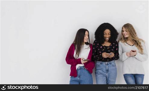 group best friends looking phone with copy space