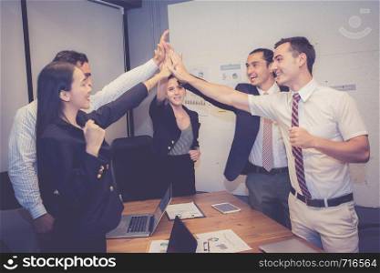 Group business asian people team with success gesture giving hi five in the meeting, agreement with achievement work of teamwork together.
