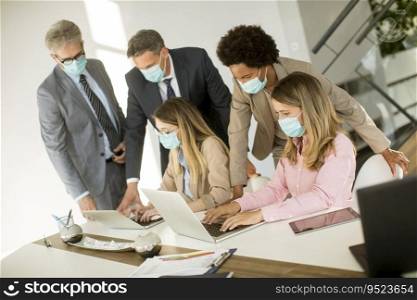 Group business people have a meeting and working in the office and wear masks as protection from corona virus