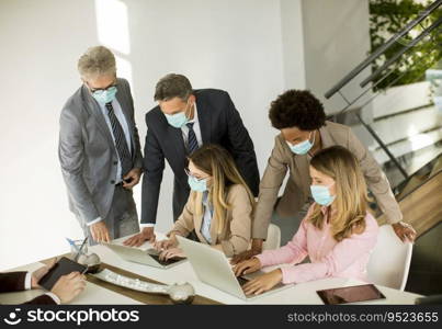 Group business people have a meeting and working in the office and wear masks as protection from corona virus