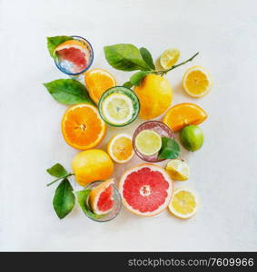 Group composition of various organic citrus fruits with green leaves on white background, top view. Healthy food. Ingredients. Vitamin. Halves and slices. Layout