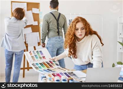 group fashion designer working atelier with color palette idea board