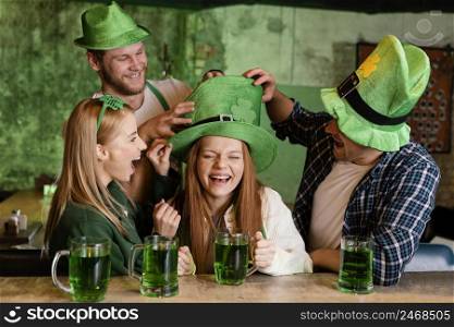 group friends celebrating st patrick s day together with drinks