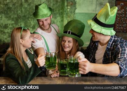 group friends celebrating st patrick s day together with drinks bar