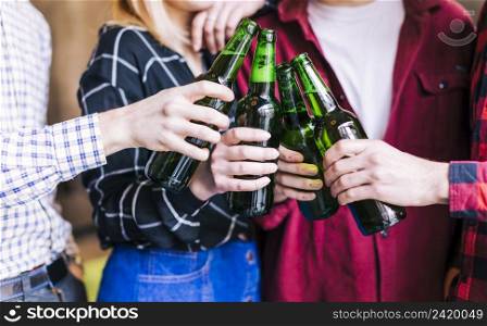 group friends clinking bottles beer