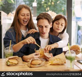 group friends fast food restaurant eating burgers