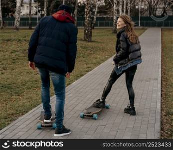 group friends skateboarding outdoors