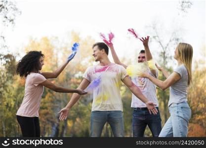 group friends throwing powdered color air