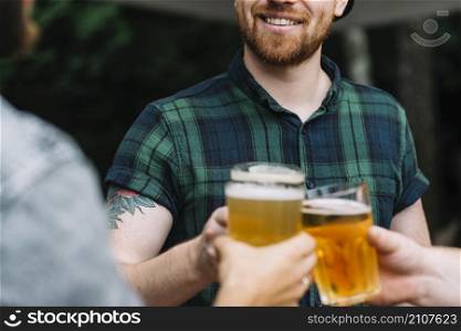 group male friends celebrating with glass beer