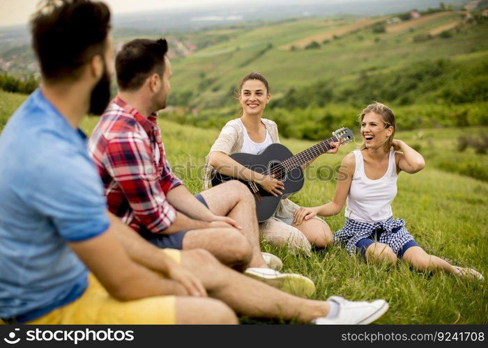 Group od young people having fun on a trip in nature on mountain