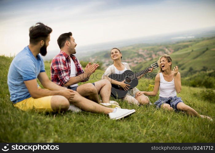 Group od young people having fun on a trip in nature on mountain