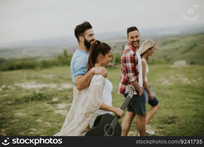 Group od young people having fun on a trip in nature on mountain