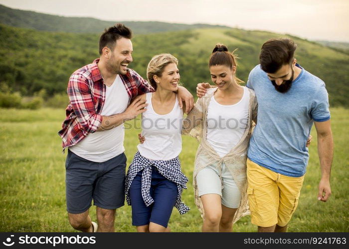 Group od young people having fun on a trip in nature on mountain