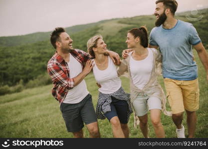 Group od young people having fun on a trip in nature on mountain