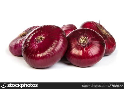 Group of a red onions, isolated against white background