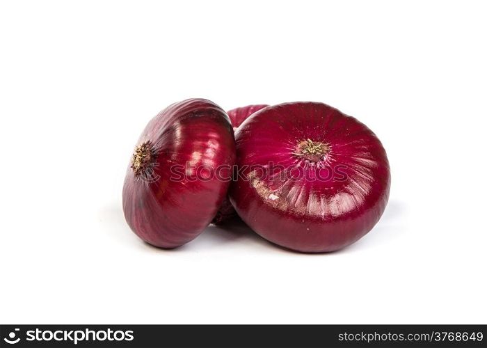 Group of a red onions, isolated against white background