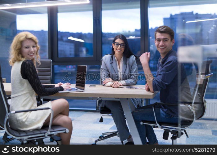 Group of a young business people discussing business plan at modern startup office building