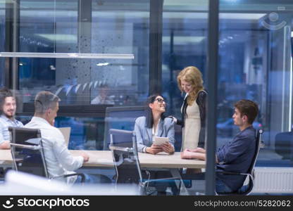 Group of a young business people discussing business plan at modern startup office building