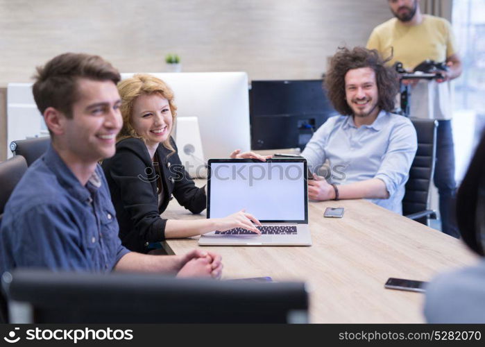 Group of a young business people discussing business plan at modern startup office building