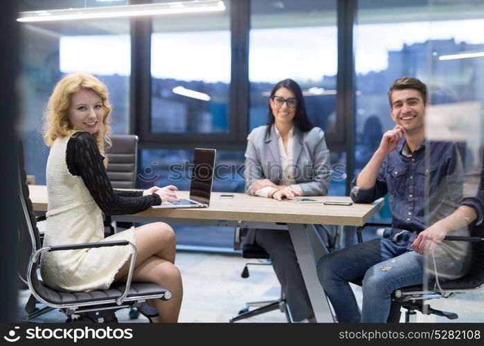 Group of a young business people discussing business plan at modern startup office building