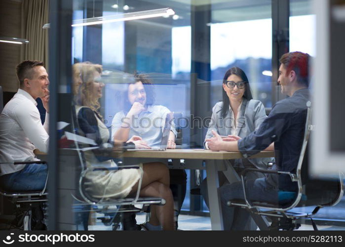 Group of a young business people discussing business plan at modern startup office building