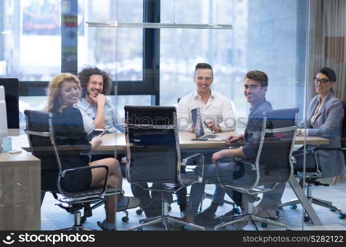 Group of a young business people discussing business plan at modern startup office building