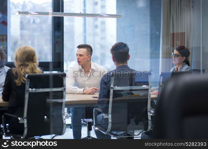 Group of a young business people discussing business plan at modern startup office building