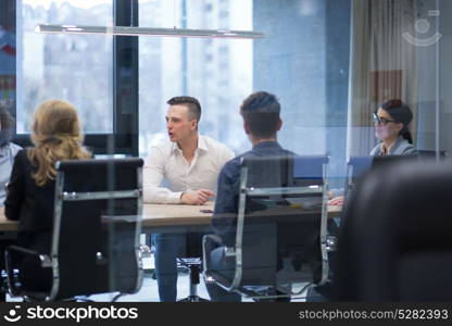 Group of a young business people discussing business plan at modern startup office building