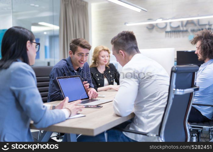 Group of a young business people discussing business plan at modern startup office building