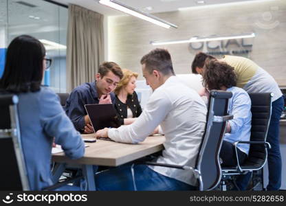 Group of a young business people discussing business plan at modern startup office building