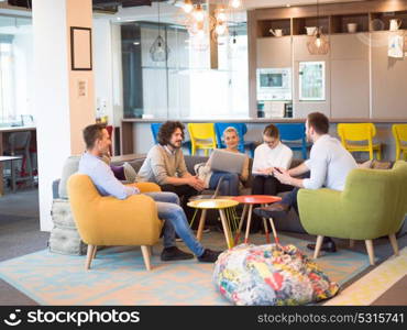 Group of a young business people discussing business plan at modern startup office building