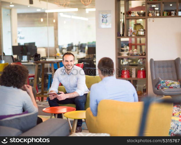 Group of a young business people discussing business plan at modern startup office building