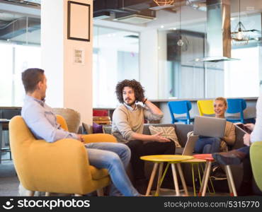 Group of a young business people discussing business plan at modern startup office building