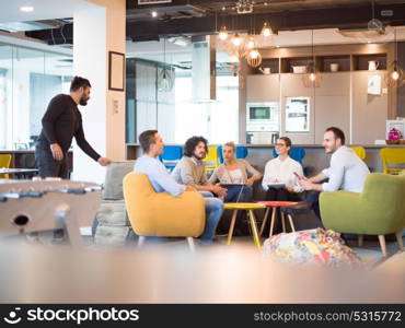 Group of a young business people discussing business plan at modern startup office building