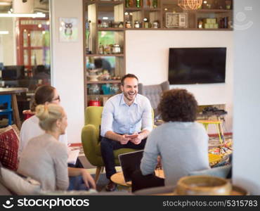 Group of a young business people discussing business plan at modern startup office building