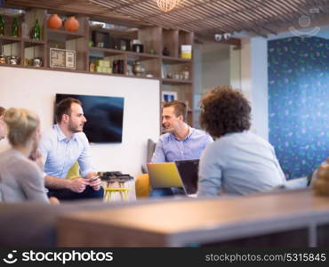 Group of a young business people discussing business plan at modern startup office building