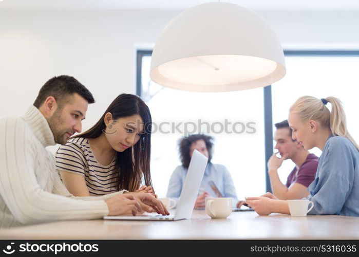 Group of a young business people discussing business plan at modern startup office building