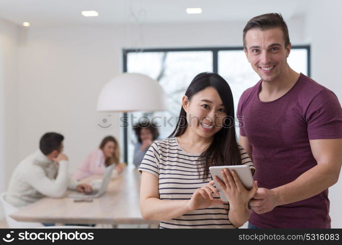 Group of a young business people discussing business plan at modern startup office building